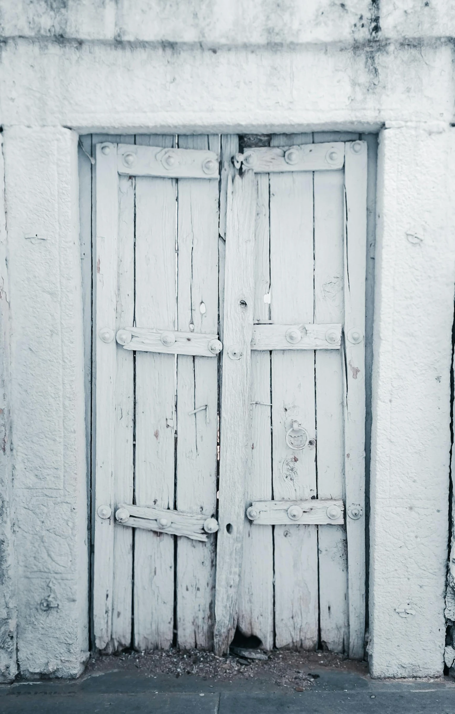 two white doors, both with a brick wall