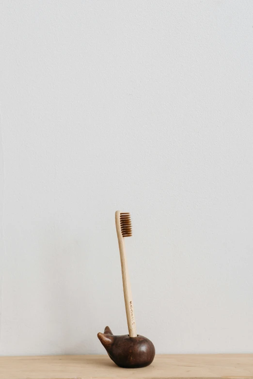 two bamboo tooth brushes on top of a table