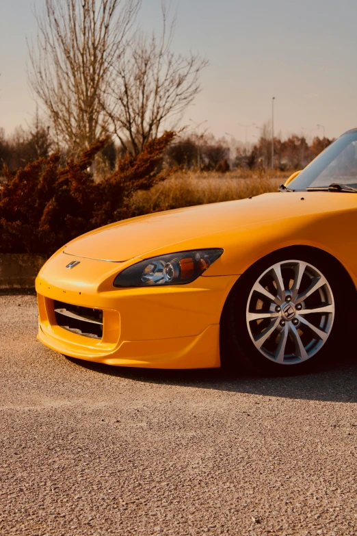 the bright yellow sports car is parked by itself