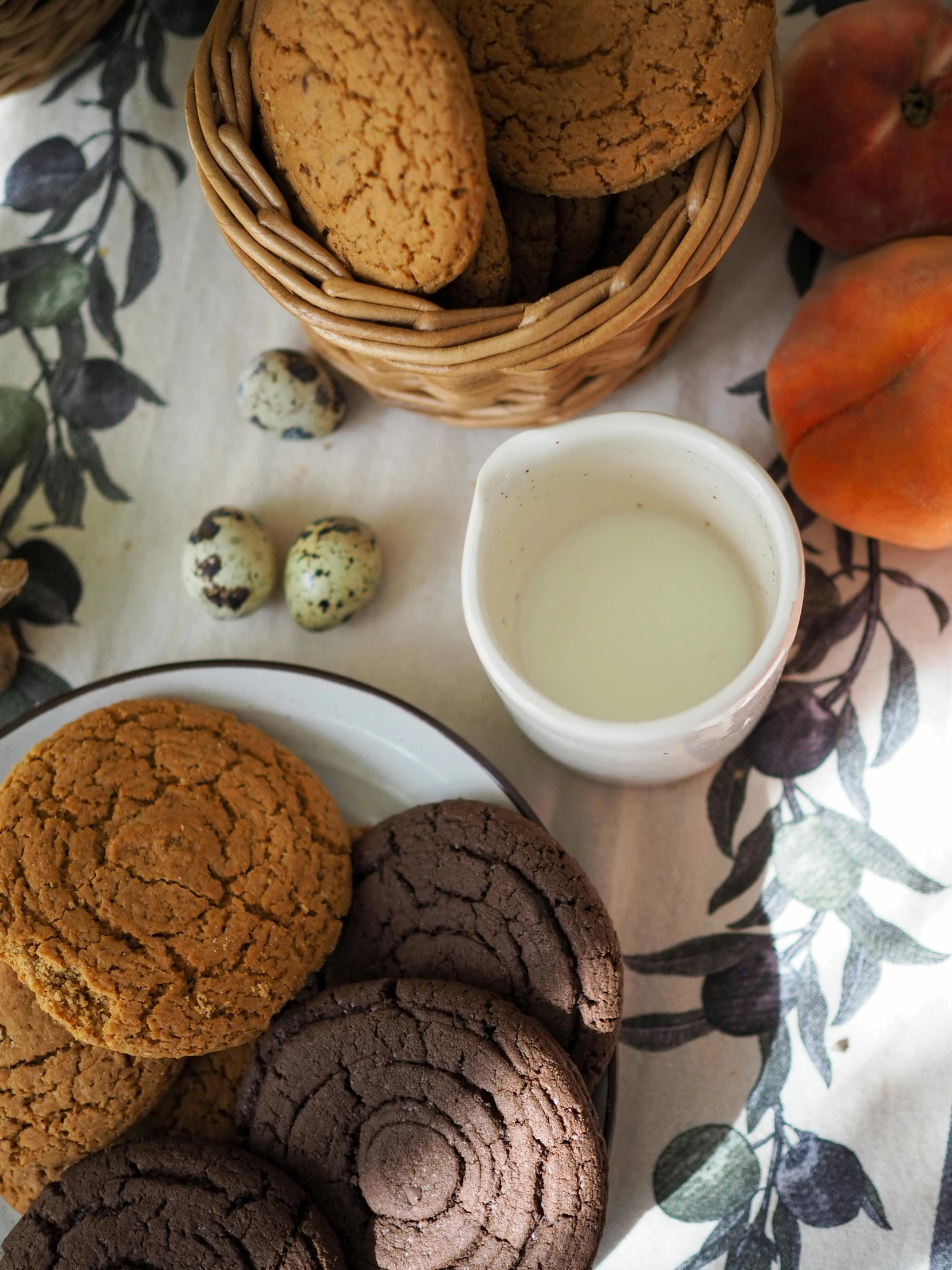 there are three cookies and several apples next to some milk