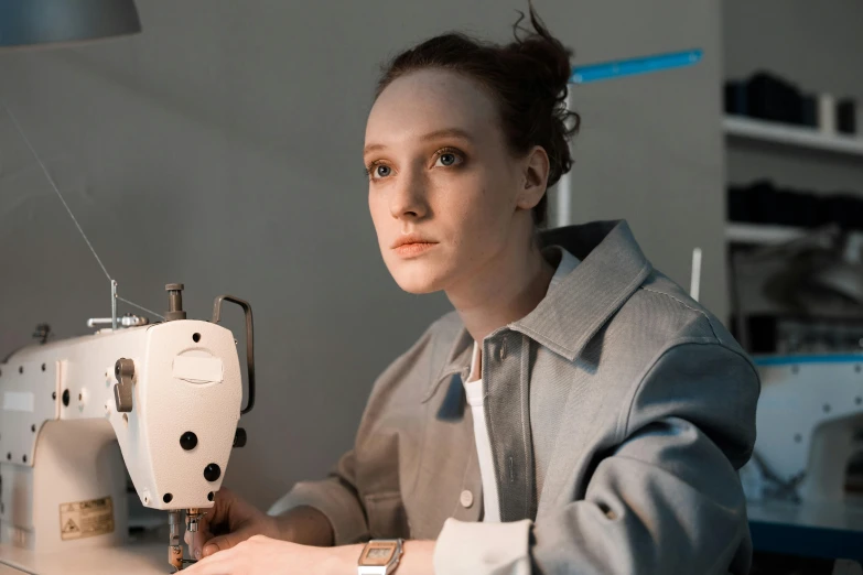 a woman working on a sewing machine in a room