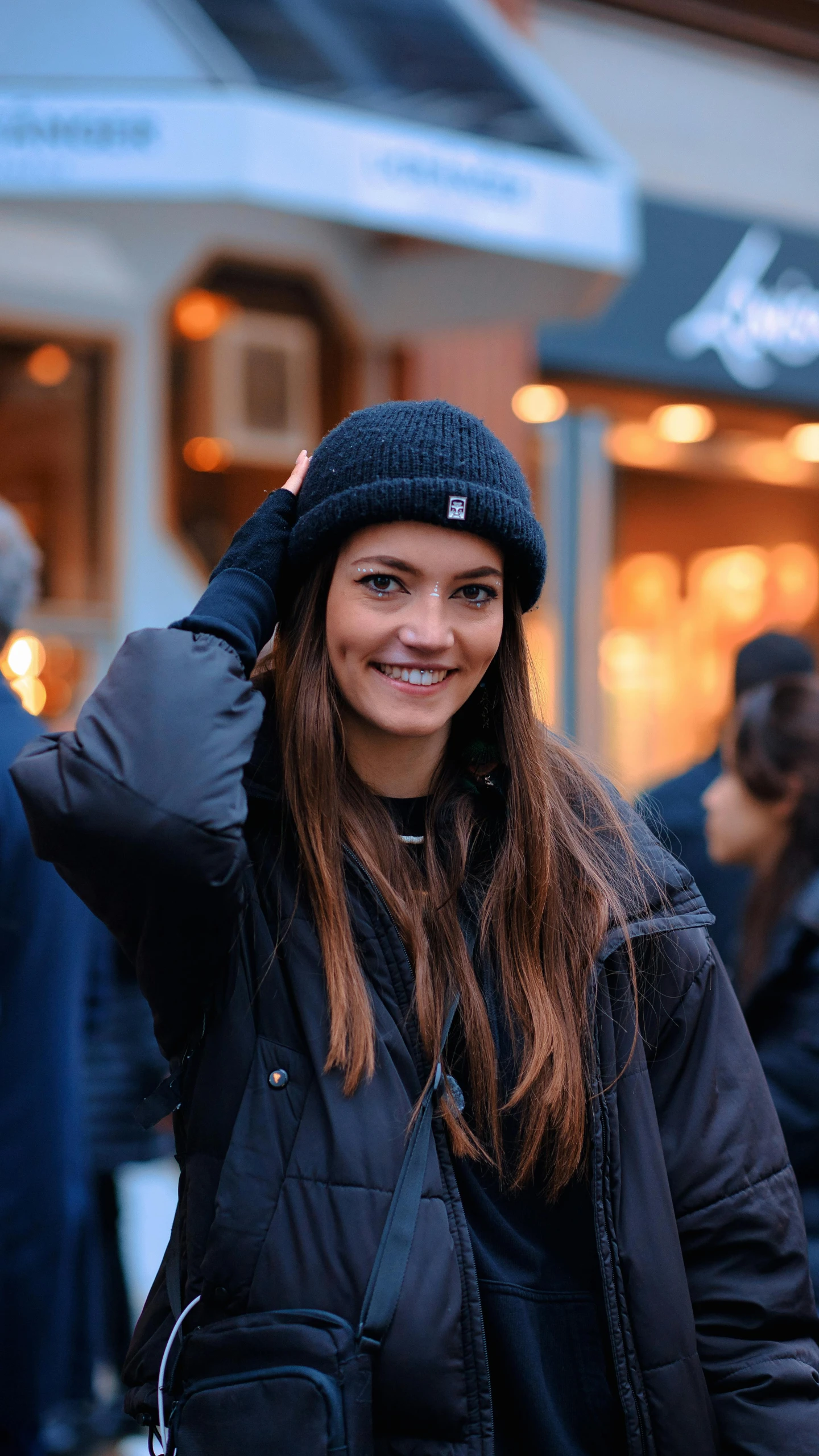 a woman holding her hair back outside