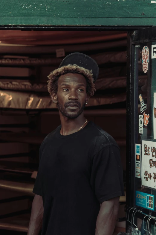 a man wearing a hat is standing in front of a vendor