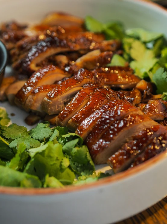 a plate of food with meat and green salad