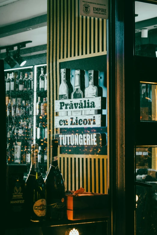 an empty bar with bottles of alcohol and liquor bottles behind glass