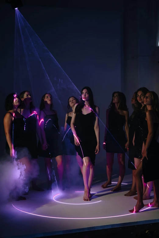 a bunch of women standing around with lights in their hand