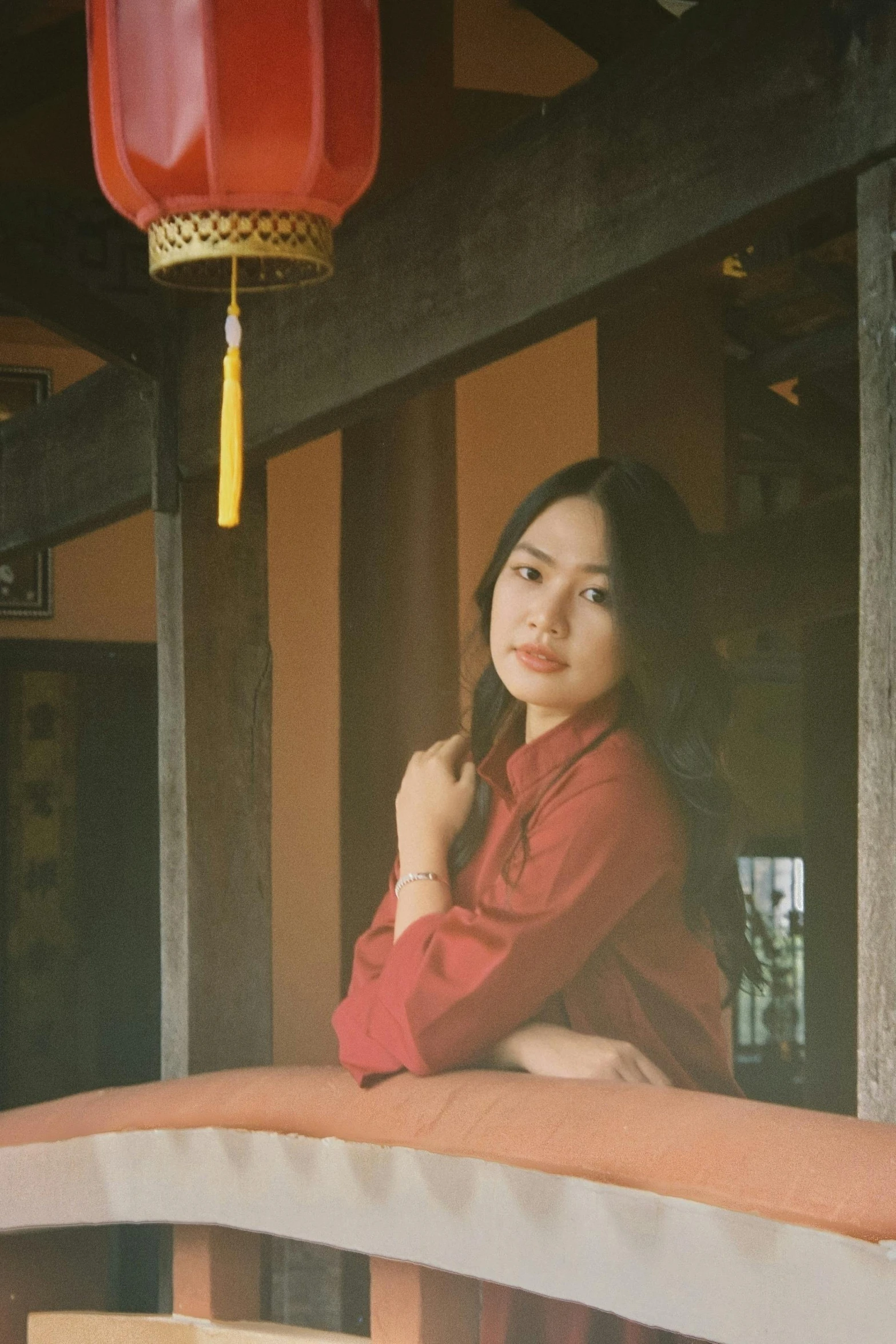 a woman is posing by some lanterns