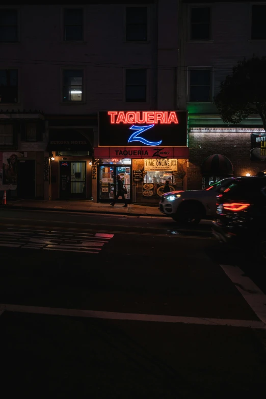 a small town restaurant in the dark with neon signage