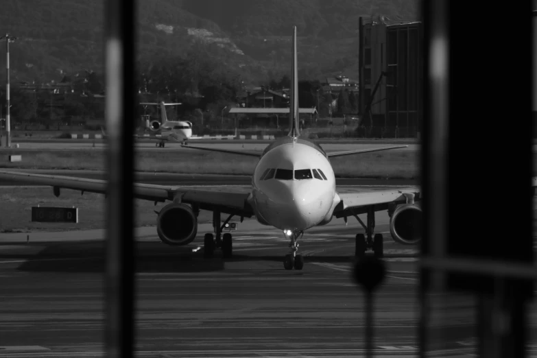 black and white po of an airplane on the runway