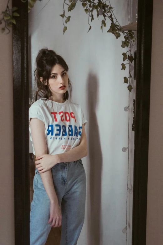 the woman is posing in front of a mirror