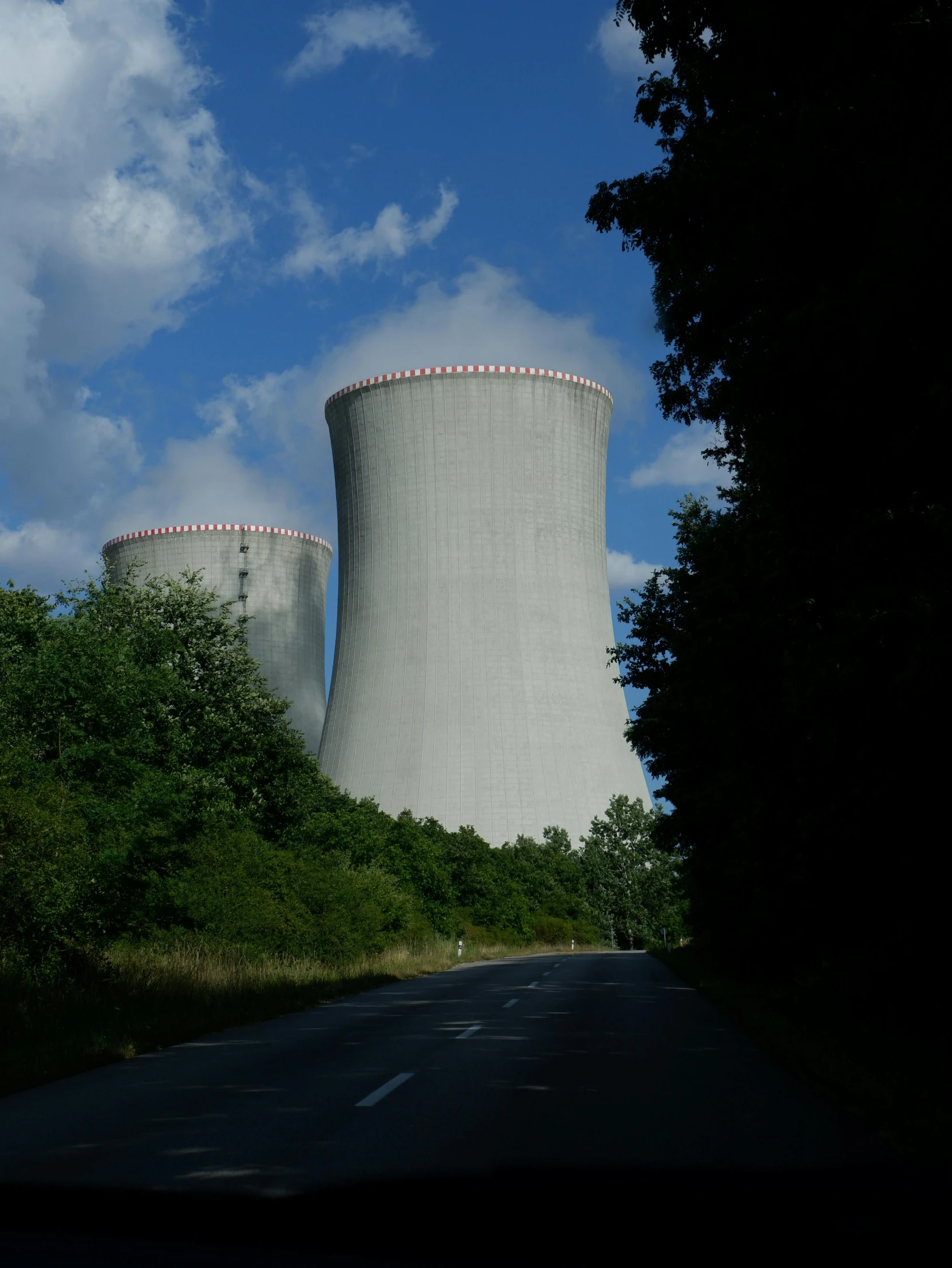a nuclear power plant towering over a rural countryside