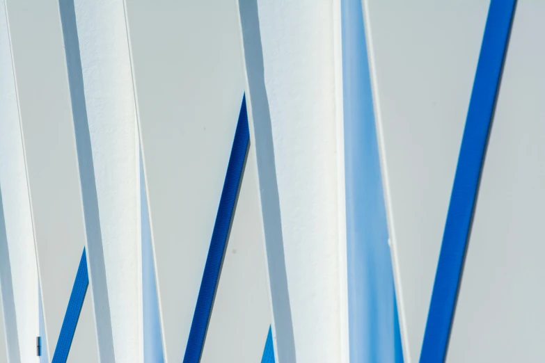 a white and blue wall is lined with stripes