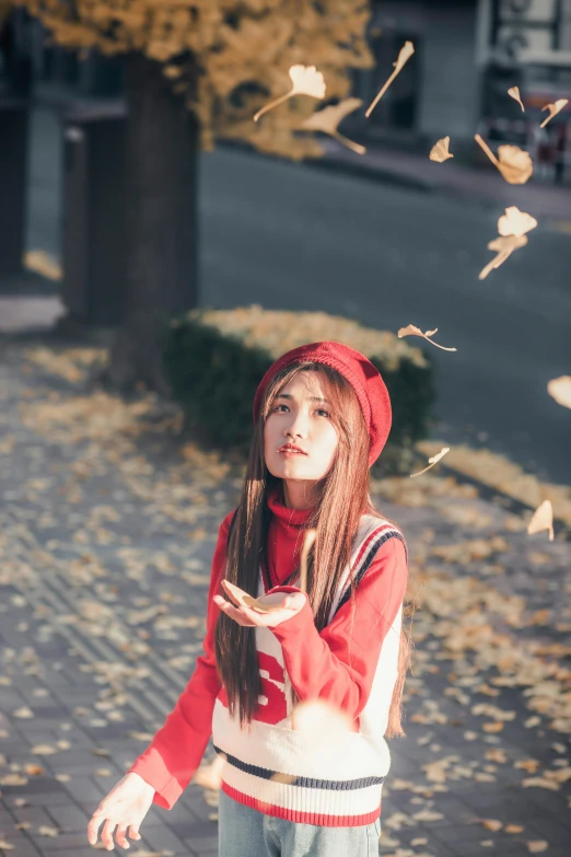 a girl stands with her hands out and has the image of a flying bird above her