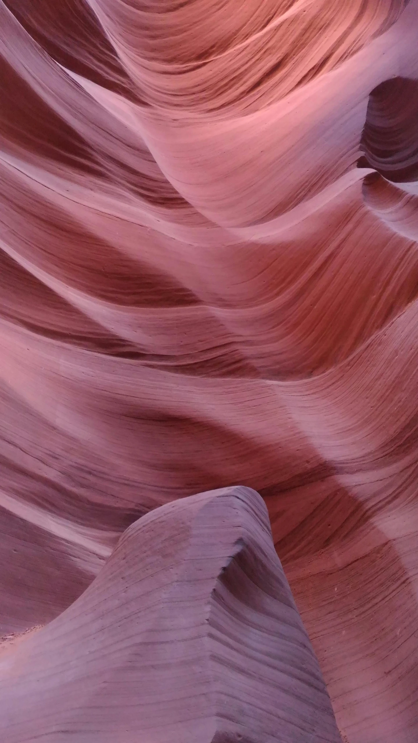 several vertically layered rock formations are seen in the desert