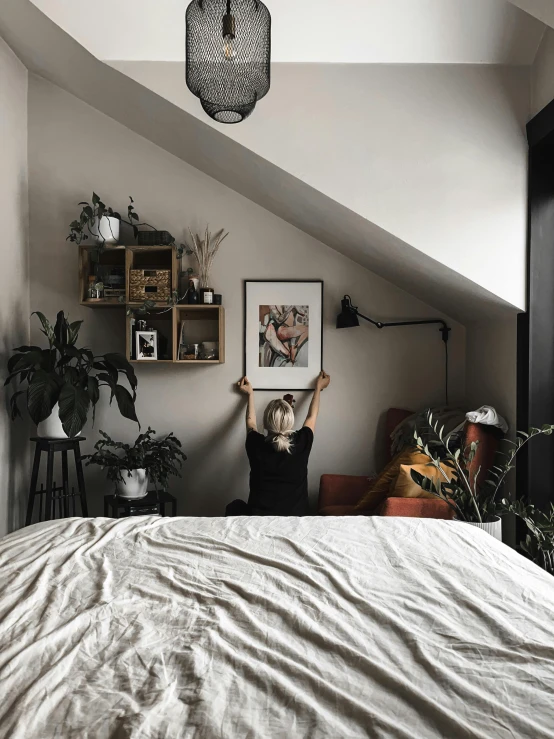 two people standing in an attic bedroom