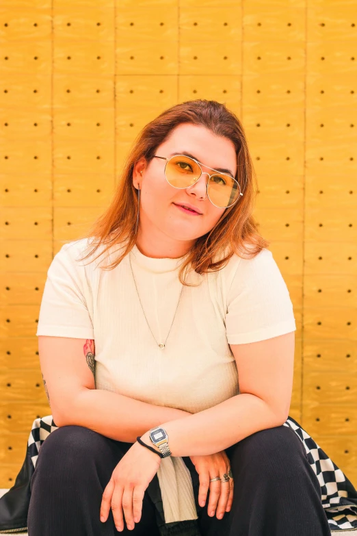 a woman wearing shades with a checkered chair