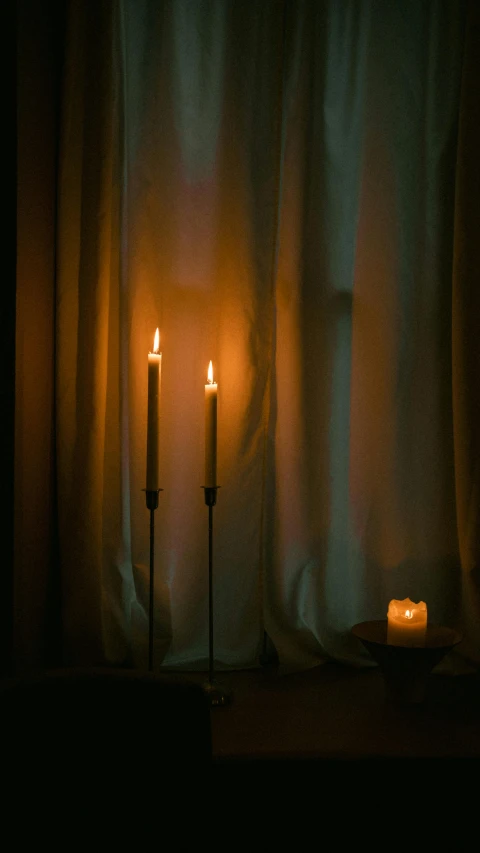 a couple of candles on top of a table