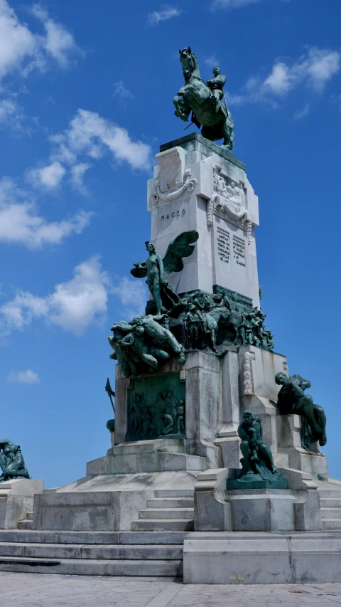 a monument with some statues at the base