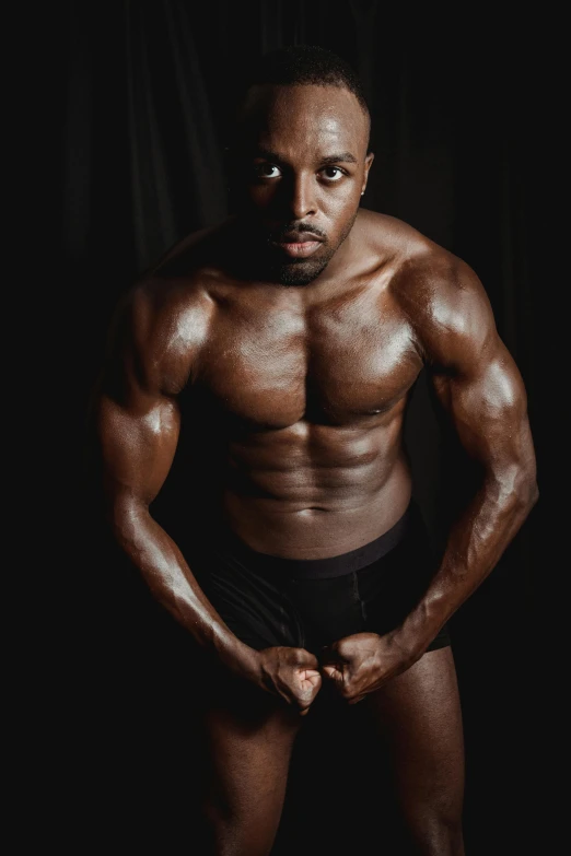 a shirtless black man posing for the camera