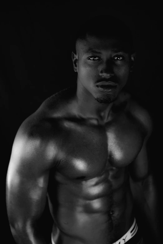 a black and white po of a shirtless man