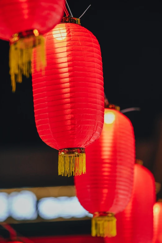 three red lanterns are hung up near each other