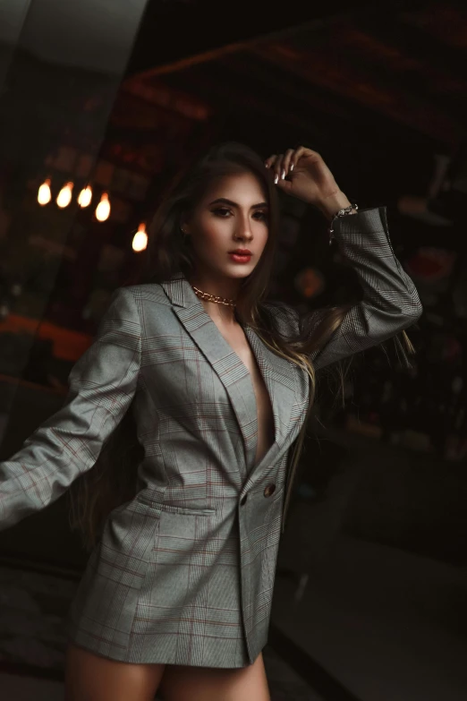 a woman in a silver suit posing for a picture