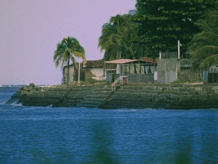 an island in the middle of the ocean with several buildings