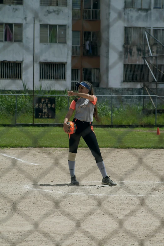 a female baseball player is preparing to hit the ball