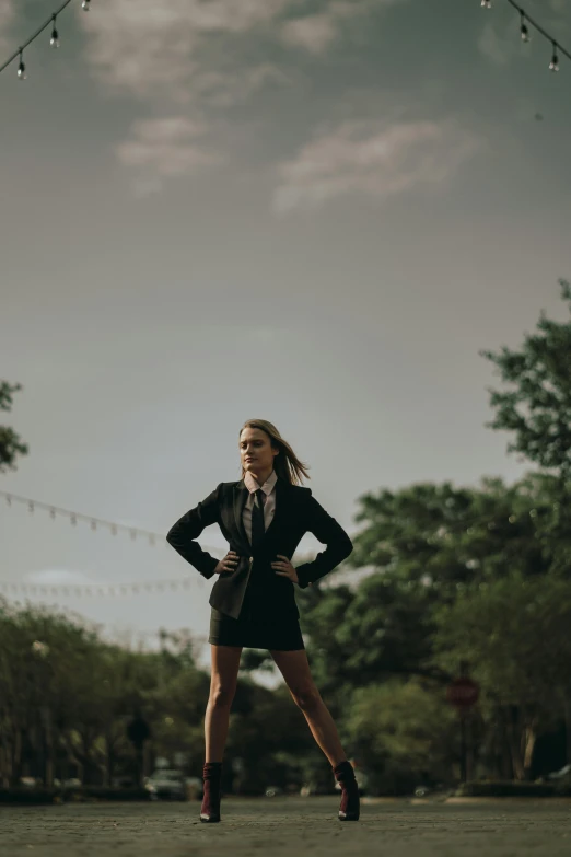 a woman is standing alone in the street