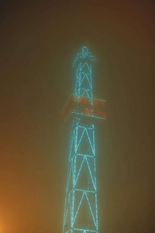 the blue clock tower has a red light on it