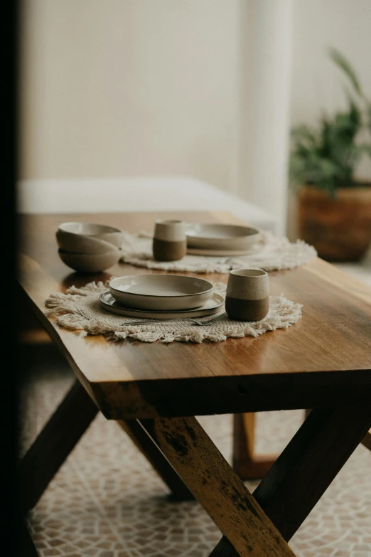 a wooden table with some plates on it