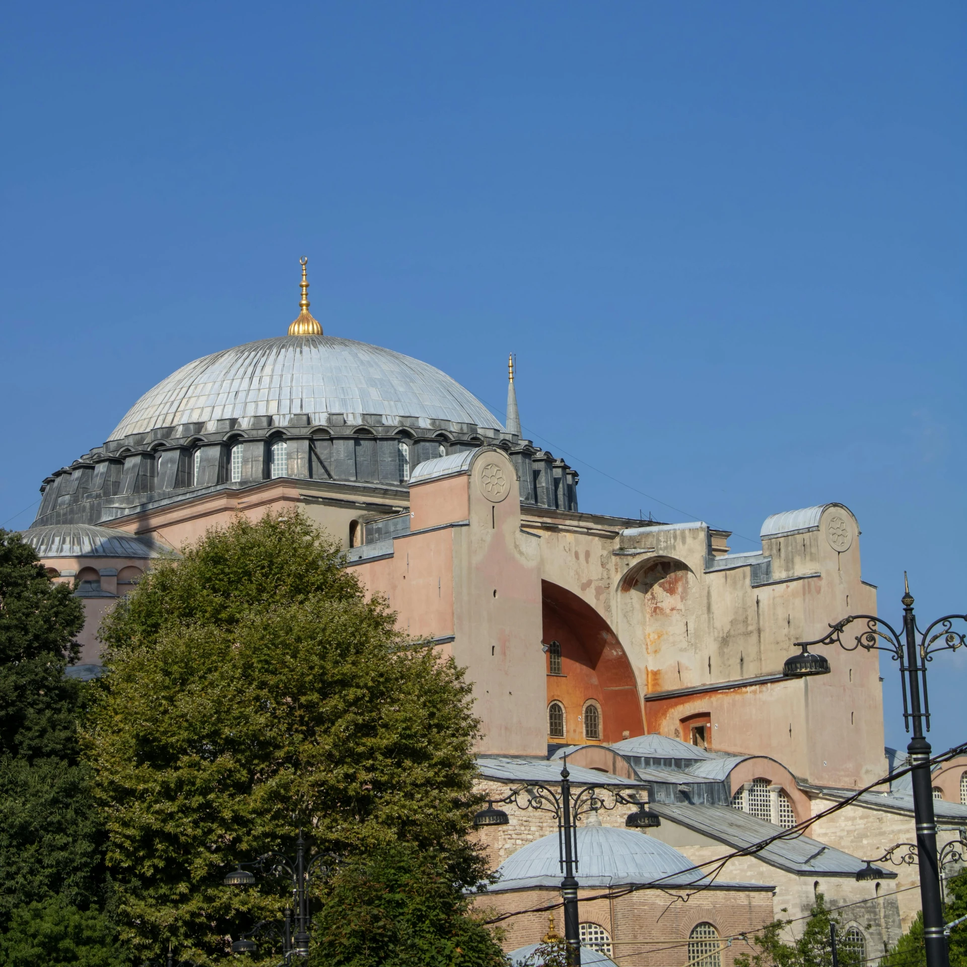 the exterior of a building with large arches and a dome