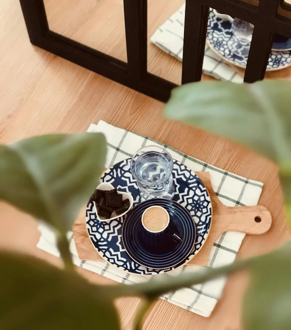 a table topped with two blue and white plates