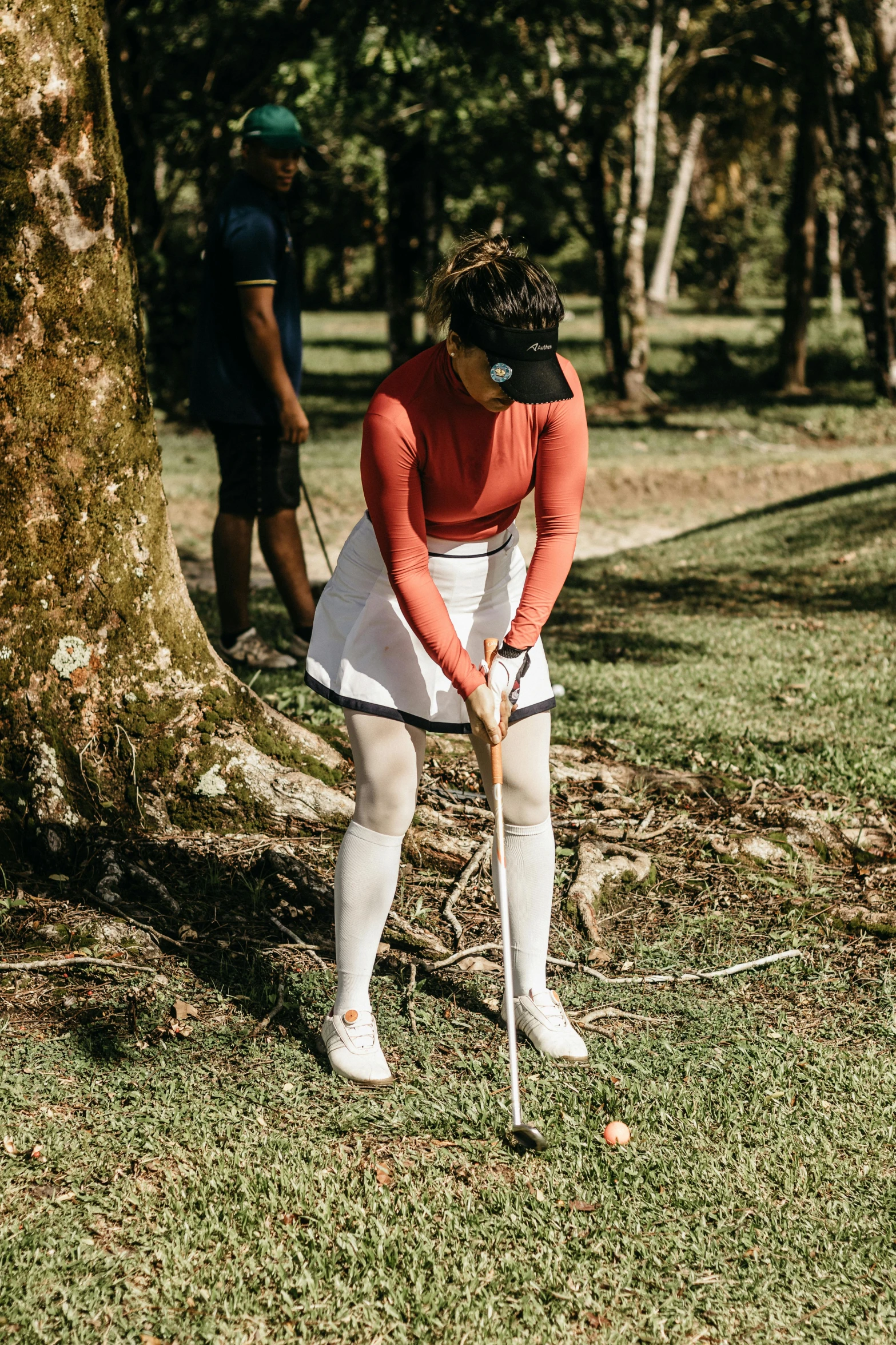 the young man is preparing to put his golf ball on the tee