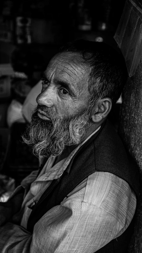 a black and white po of a man with a beard