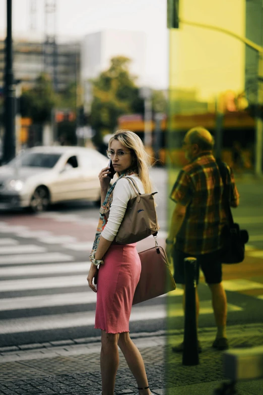 the woman is looking at her cell phone while walking