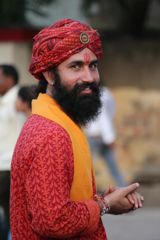 man in an indian outfit with a beard and big turban