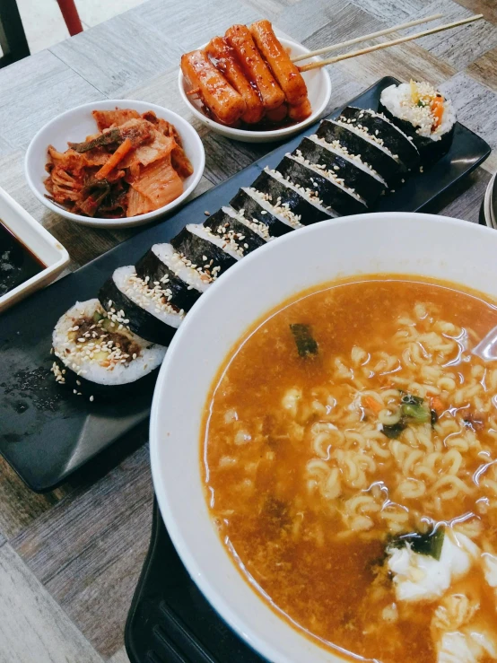 a large bowl of soup and other foods on a table