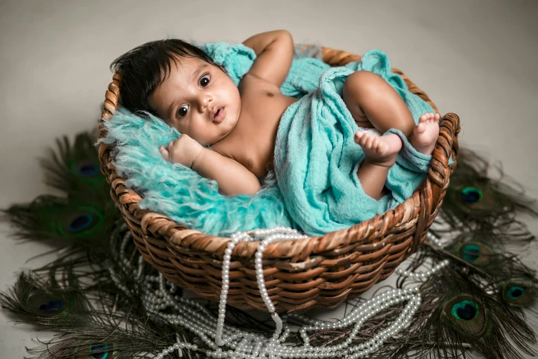 a small baby is laying in a basket