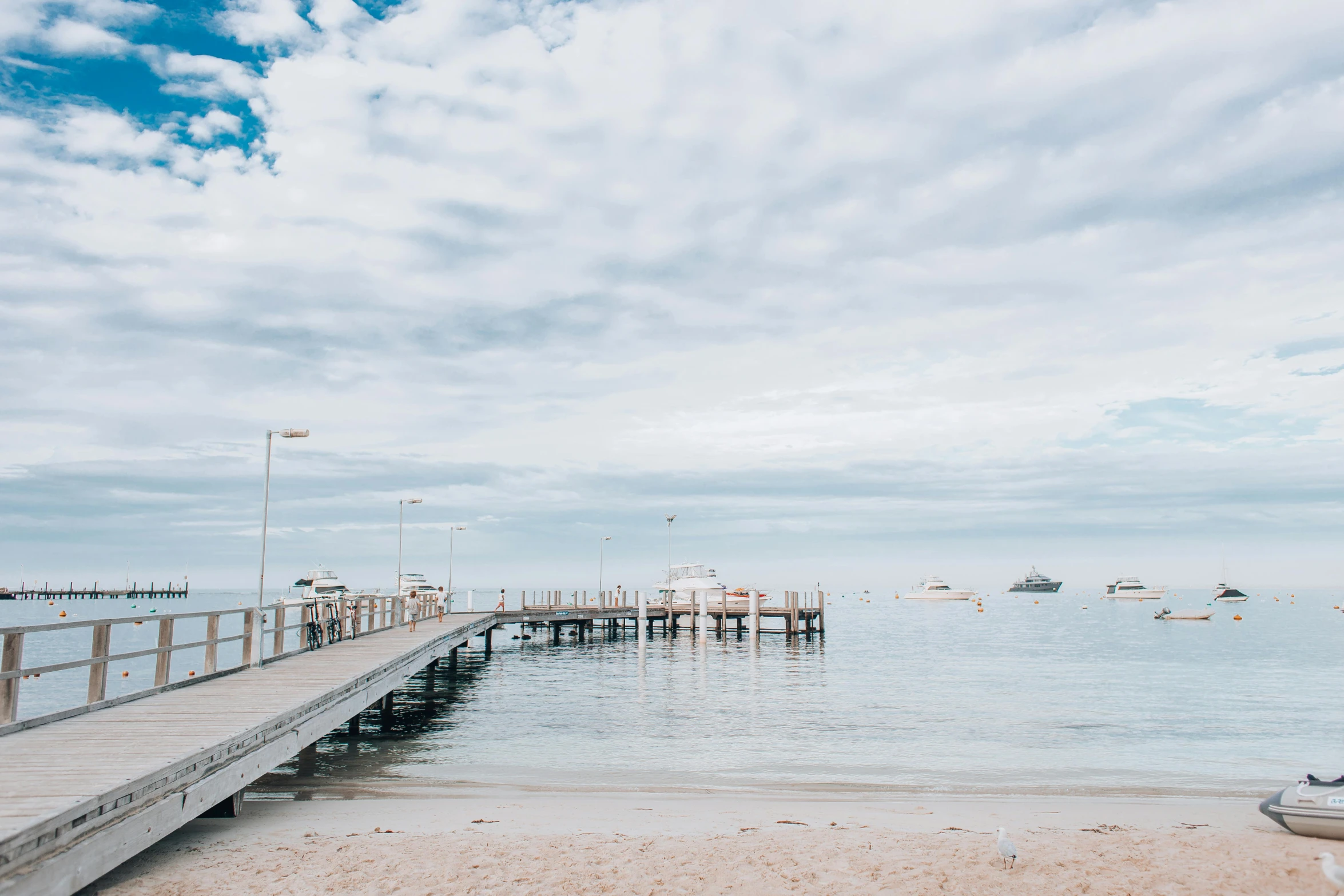 people enjoying a day on the pier by the sea