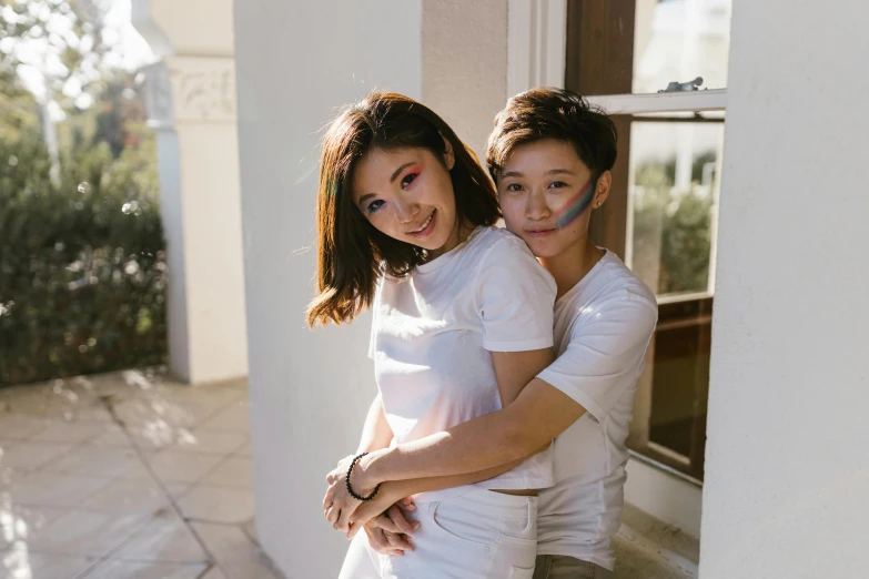 a man and woman hugging each other by the wall