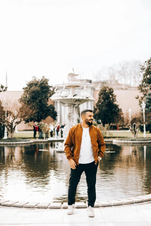 a man standing in front of the water fountain