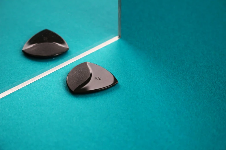 two guitars picks are placed side by side on a blue background