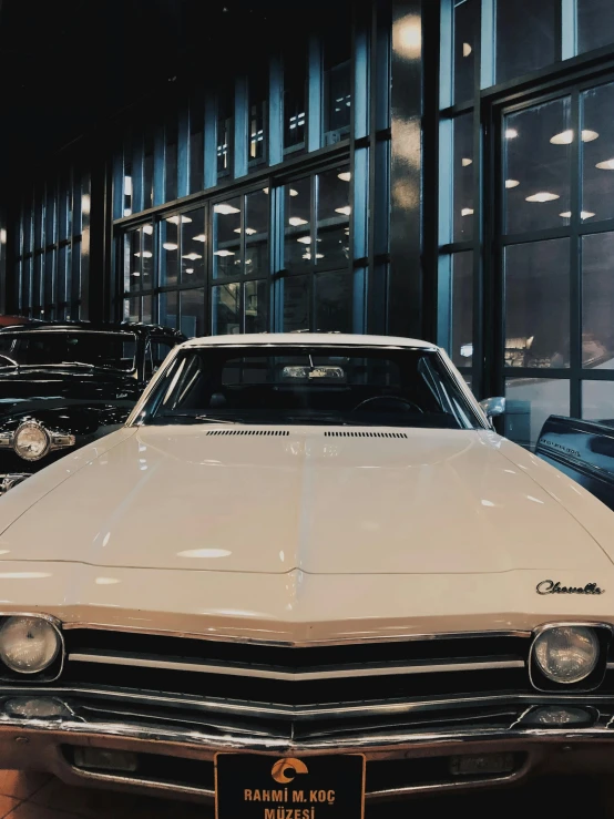 an old car is on display in a garage