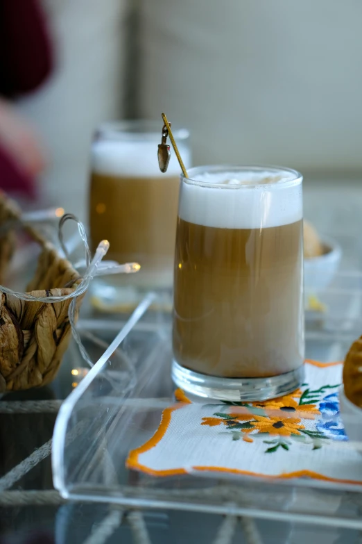 there are two drinks and cookies on the table