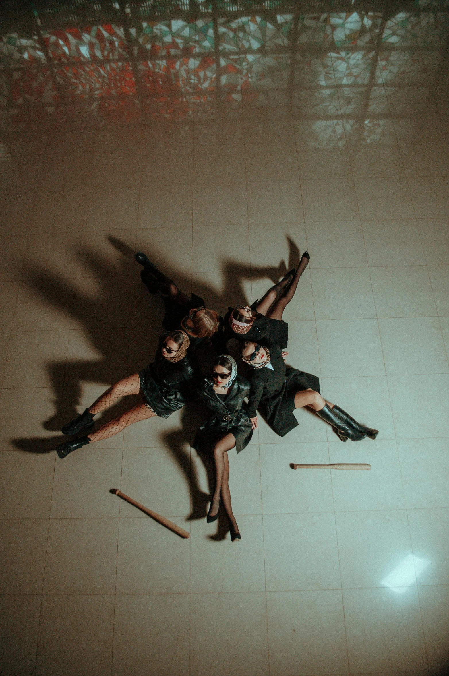 four people pose for a po in the middle of a tile floor