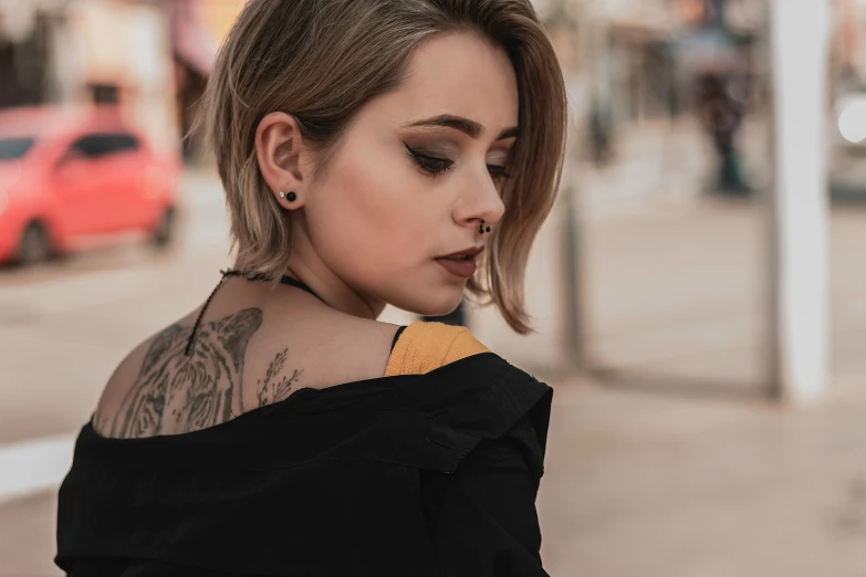 a woman with tattoos is on the street