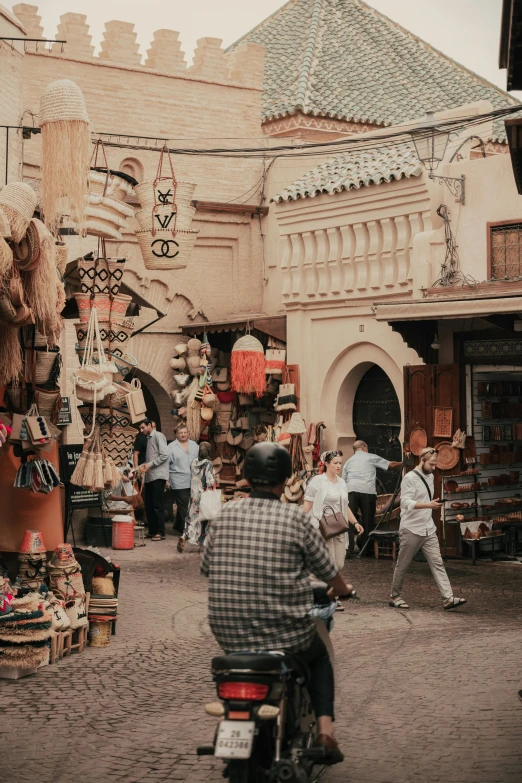 a group of people shopping outside in the street