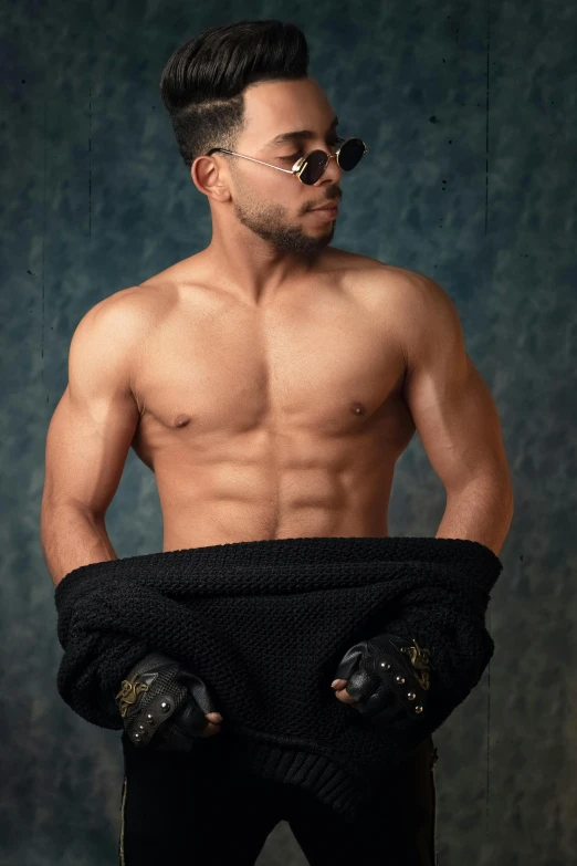 shirtless male athlete in black shorts with sunglasses