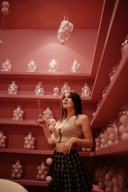a woman standing in a room filled with shelves